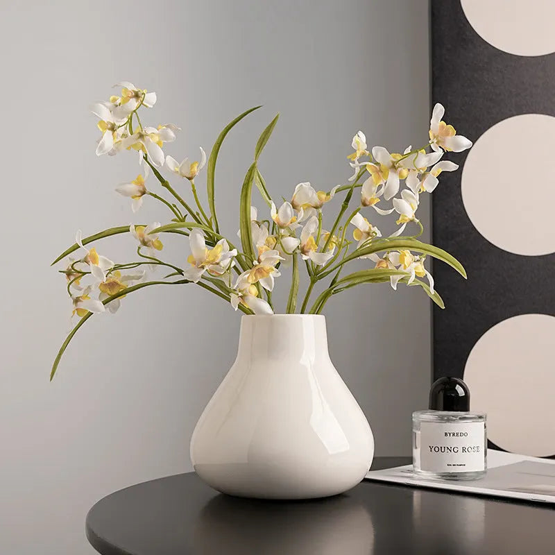 Black ceramic round belly French design vase with two white orchid flowers