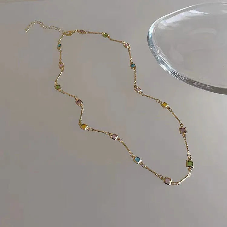 Square colour crystal clavicle chain necklace with geometric pendants in gold tone finish