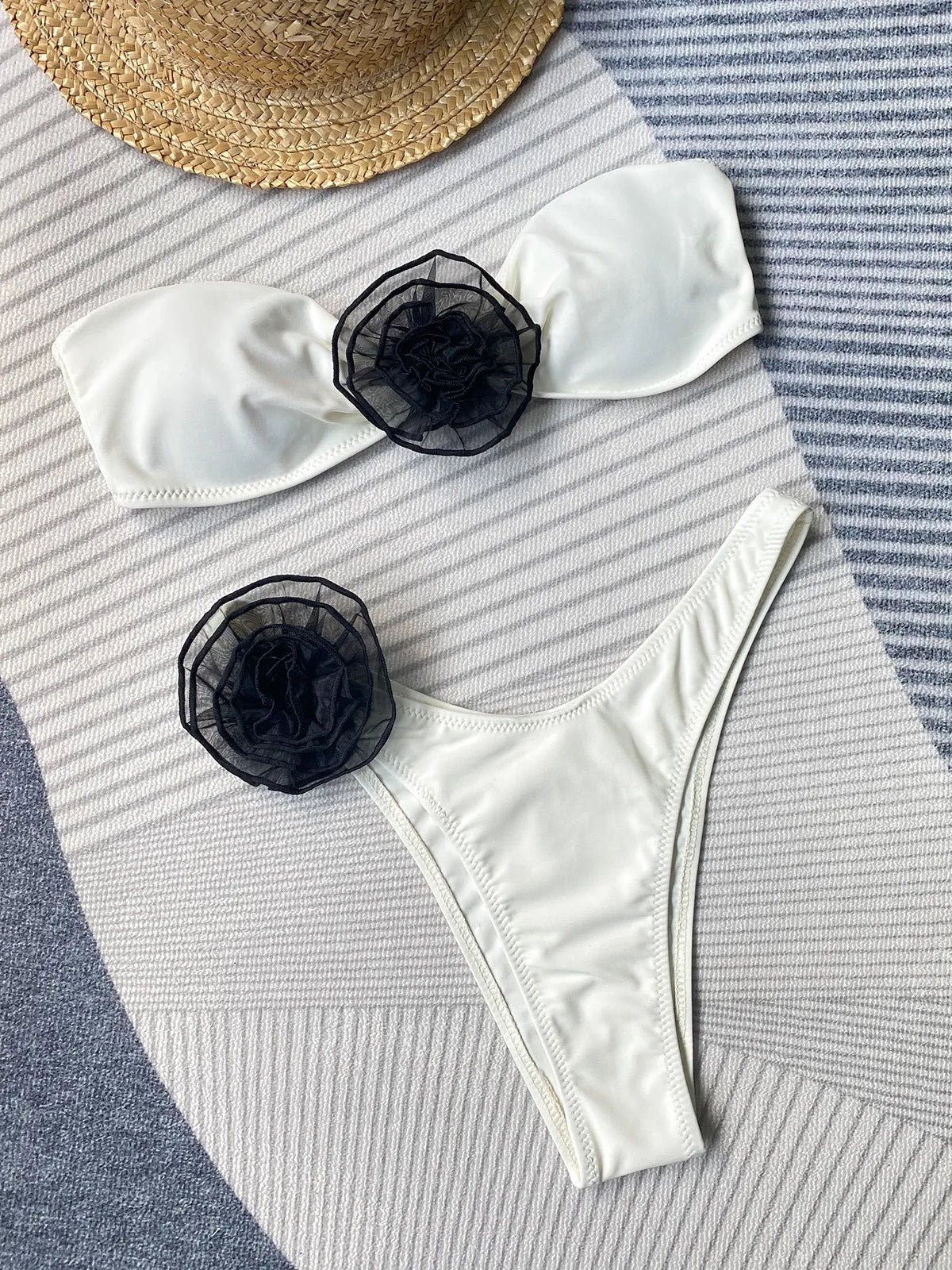 Striped bikini set with floral detail, removable halter tube top, and high-split skirt shorts on a mannequin.