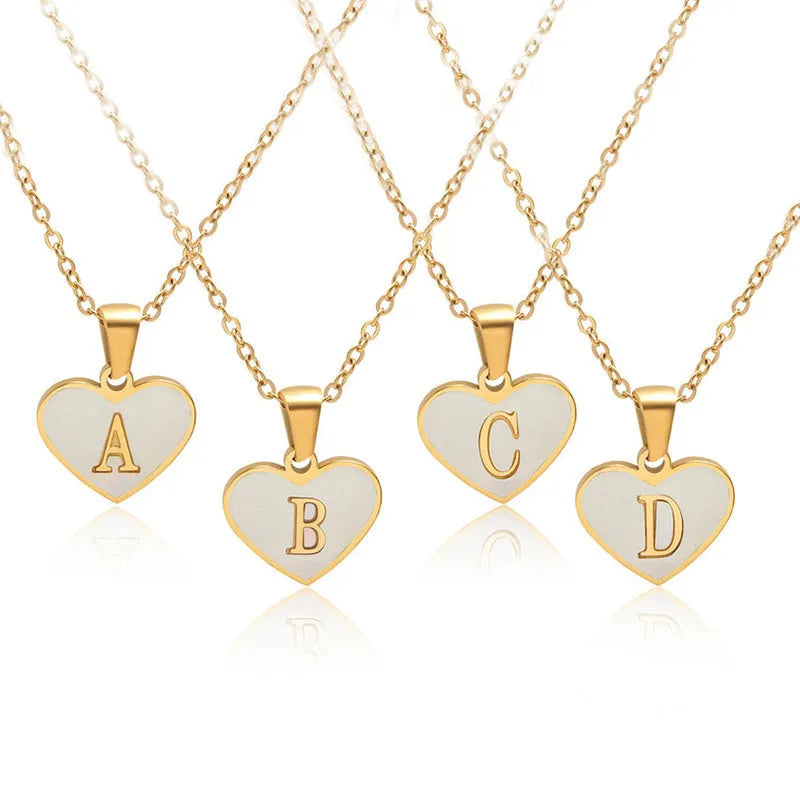 Gold plated heart-shaped white shell pendant personalised initial necklace on a stainless steel chain.