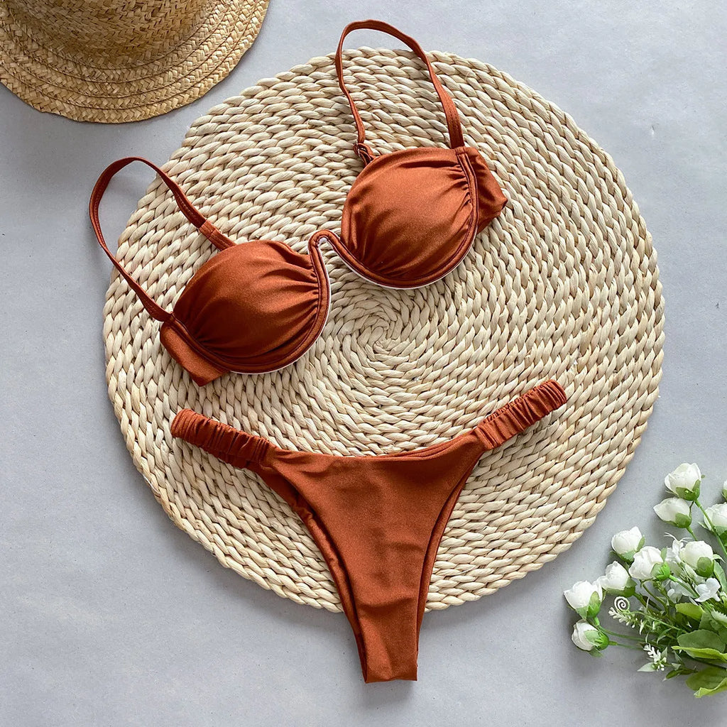 Women's black underwire bikini top and briefs set on a mannequin, showing sleeveless design.