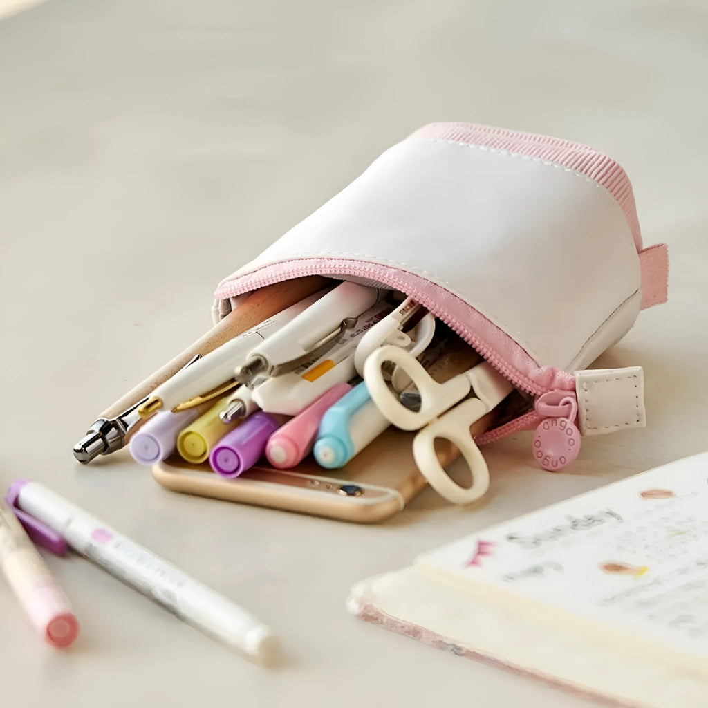 Corduroy drop-down telescopic stationery case in six colour options on a desk