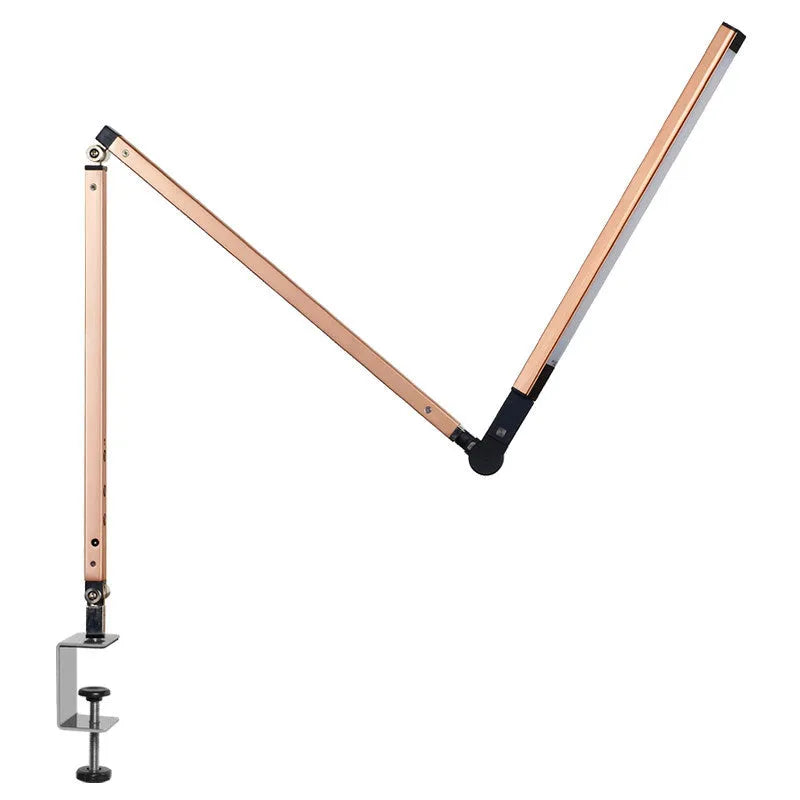 Black adjustable clip-on desk lamp with flexible arm and remote control on a wooden desk