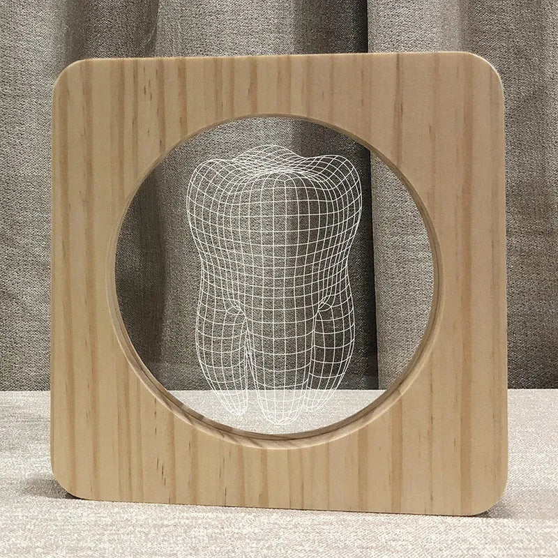 Tooth-shaped wood colour acrylic USB night light on a surface, showing its compact size.