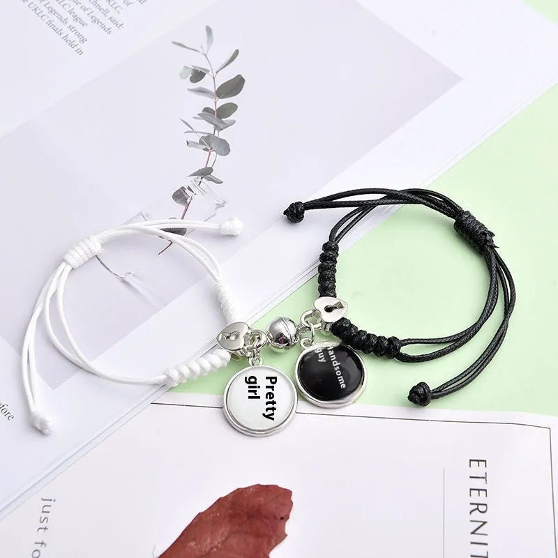 Pair of alloy suction bracelets with engraved symbol choices including crown, love lock, and clover.