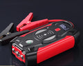 Red car emergency jump starter power bank with digital display and jumper cables