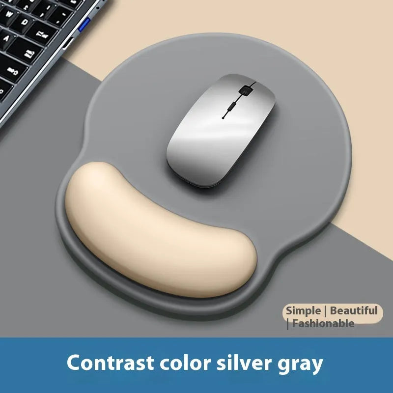 Silicone mouse mat with attached gel wrist support in a gradient blue colour on a desk.