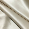 Dark gray envelope closure silk pillowcase on a bed