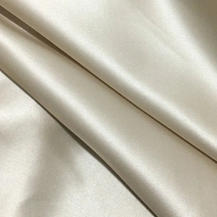 Dark gray envelope closure silk pillowcase on a bed