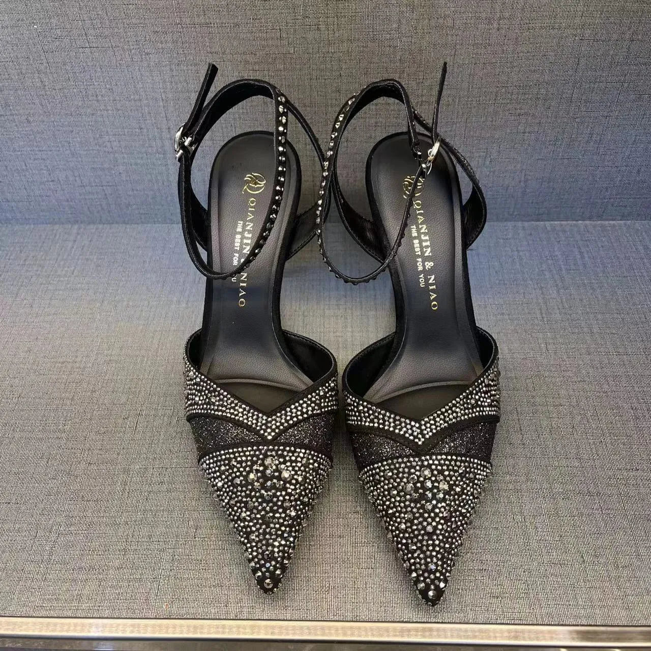 Women's silver and black stiletto heels with red sole and hollow design, pointed toe formal shoes