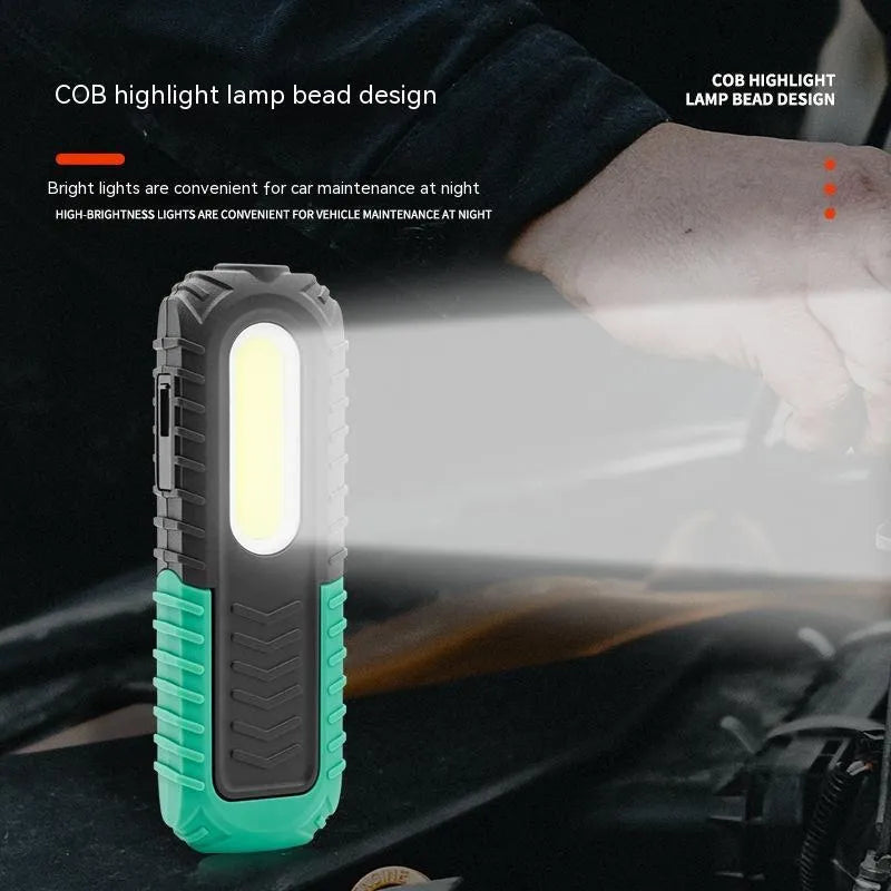 Black and green USB-charged automotive inspection work light with compact design