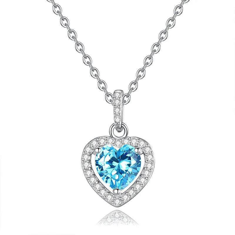 Heart-shaped sterling silver pendant necklace with a natural gemstone on an adjustable chain.