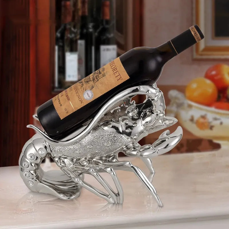 Lobster-shaped decorative wine rack ornament in metallic rose gold holding a wine bottle.