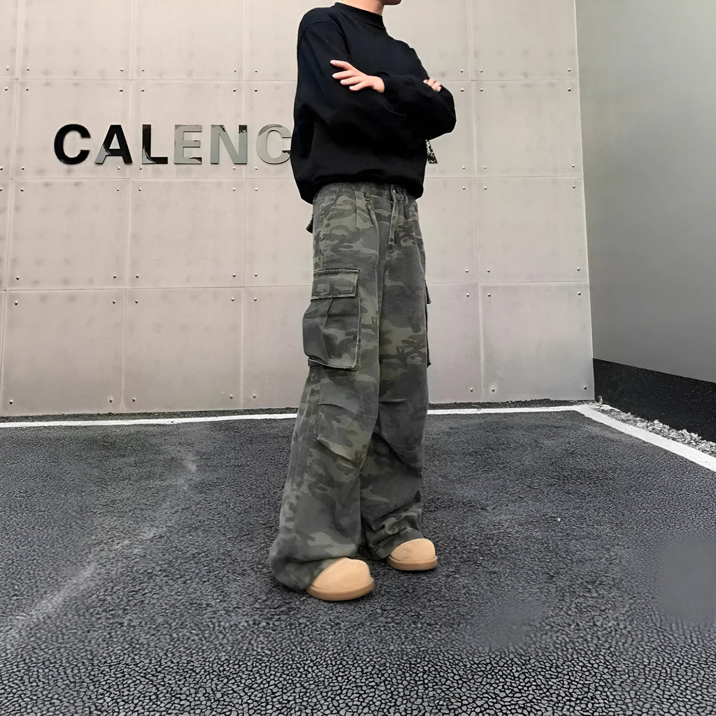A pair of washed camouflage print cargo pants with multiple pockets on a mid-waist, showing the full trouser length.