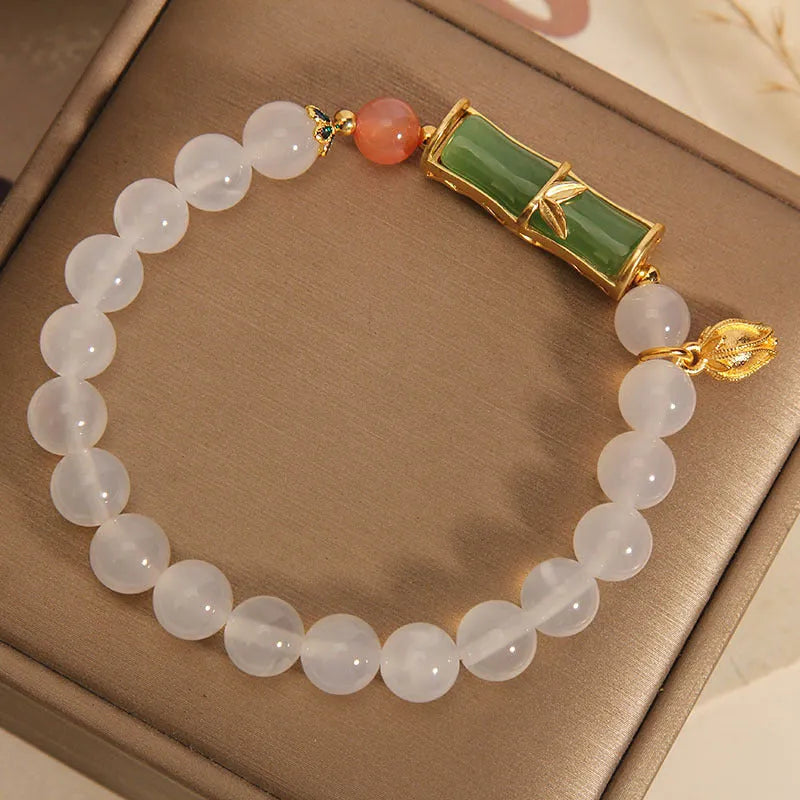 Women's white agate jasper bamboo bead bracelet with a single central jade focal bead.