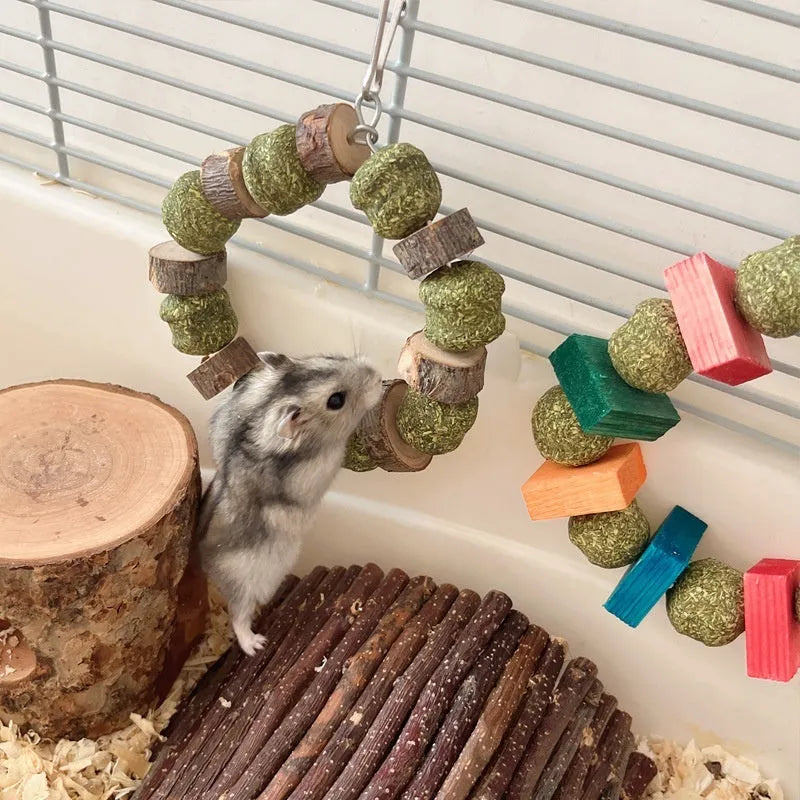 Hamster chew toy with a straw ball ring and natural applewood molar rod on a white background.