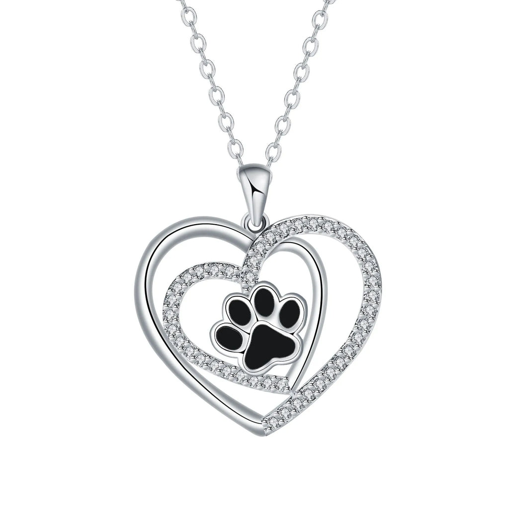 Women's necklace with a heart-shaped dog paw print copper pendant on a cross chain.