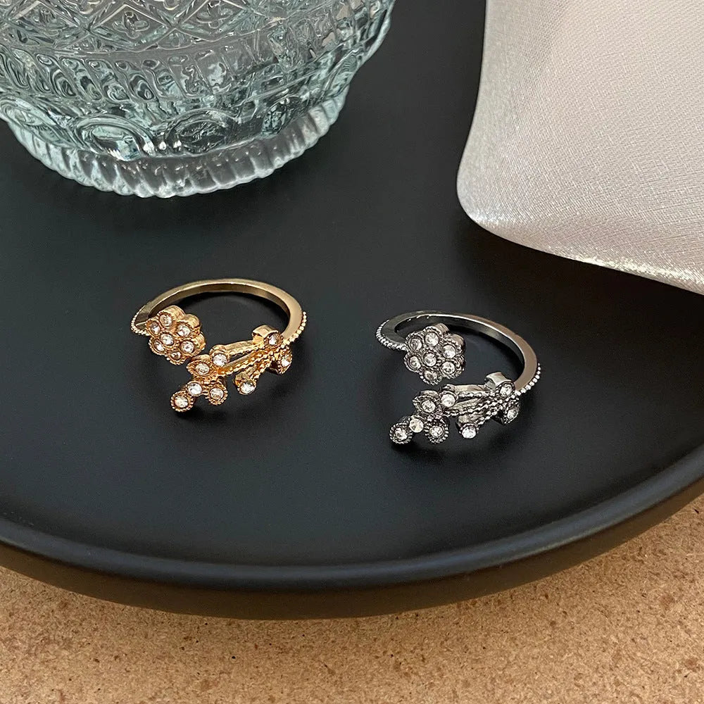 Women's copper floral open ring with diamond finish showing gold and white colour options