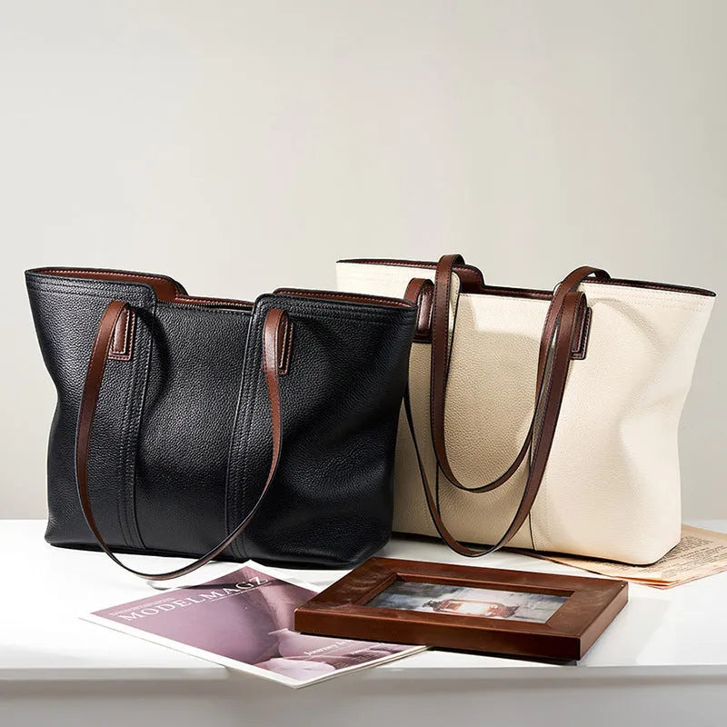 Women's black horizontal square leather commuter shoulder bag with crossbody strap and internal organiser pockets.