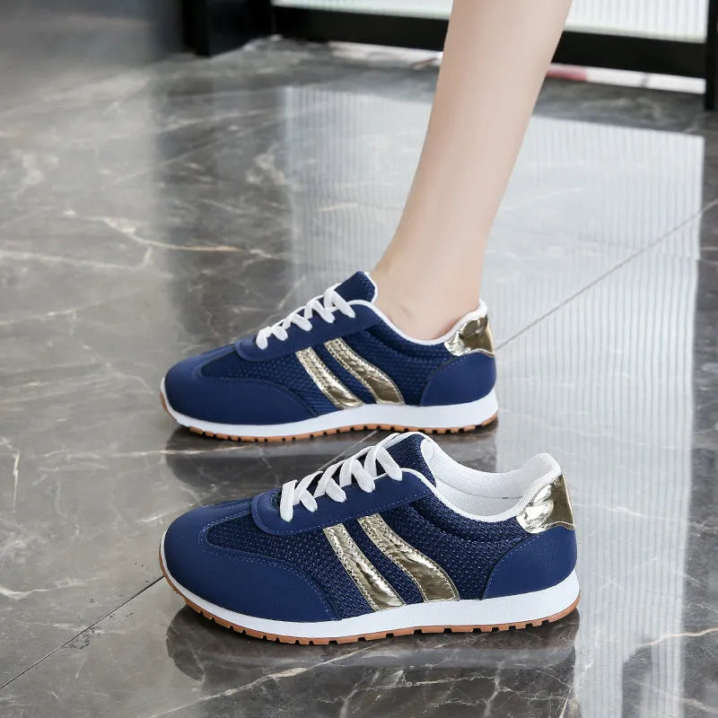 Blue women's casual sports shoes with lace-up front, cross shoulder straps, and a flat non-slip rubber sole.