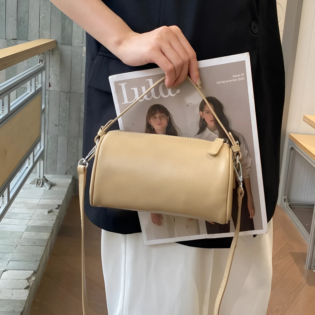 Soft genuine leather cylindrical crossbody phone bag in street style with sewing thread detailing