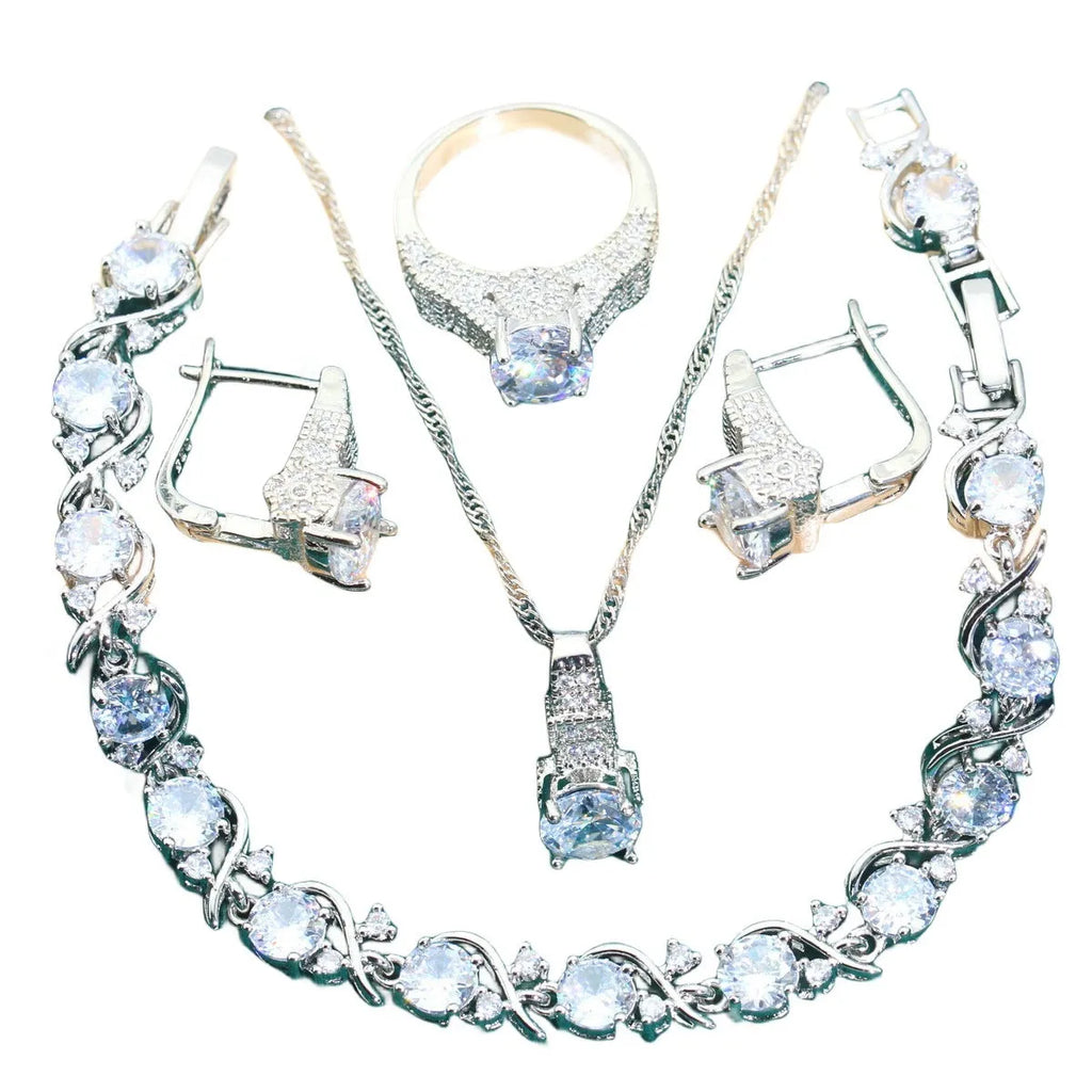 Four-piece bridal jewellery set showing necklace, earrings, ring, and bracelet with alloy pendant and water wave chain