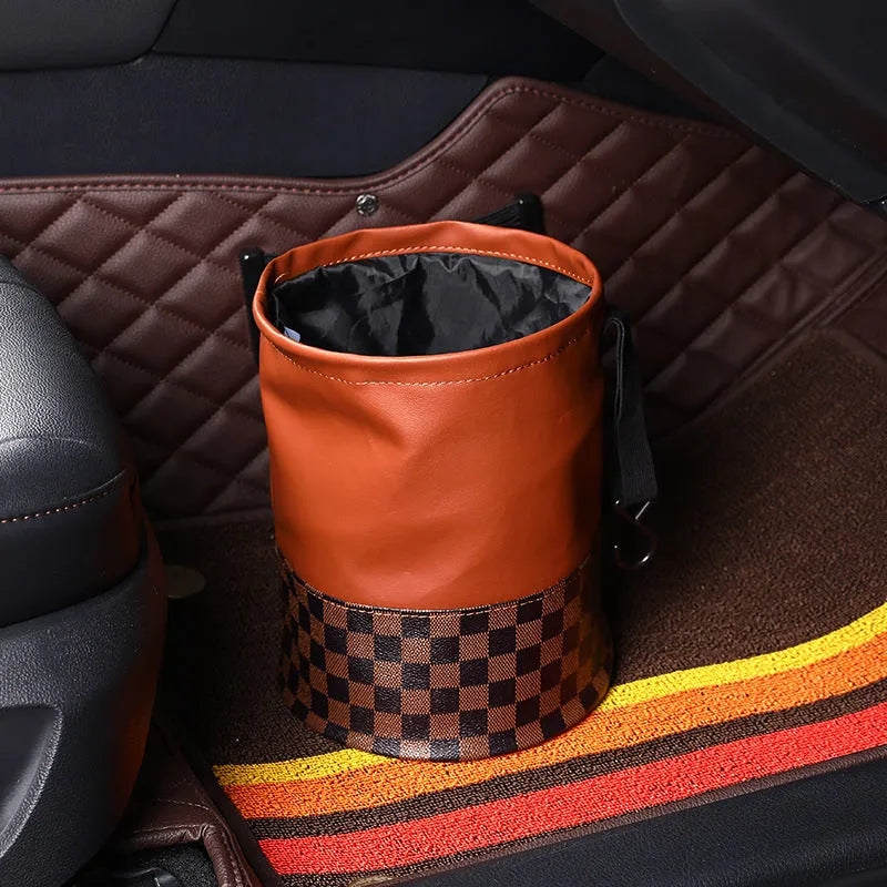 A retractable leather car trash can shown in a vehicle, featuring a carry handle.