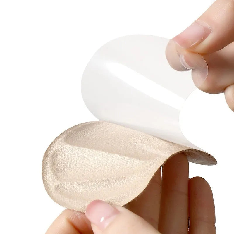 Three pairs of camel-coloured suede heel cushion pads with adhesive backing for shoes.