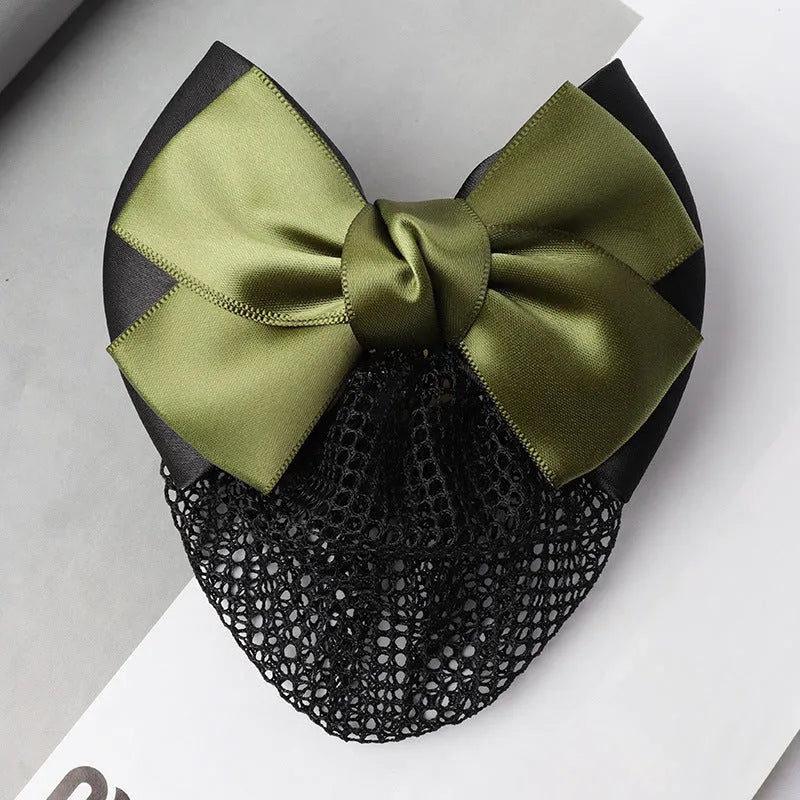 Professional flower bow headdress hair clip ornament on a work plate, shown in a selection of net and mesh colour variations.