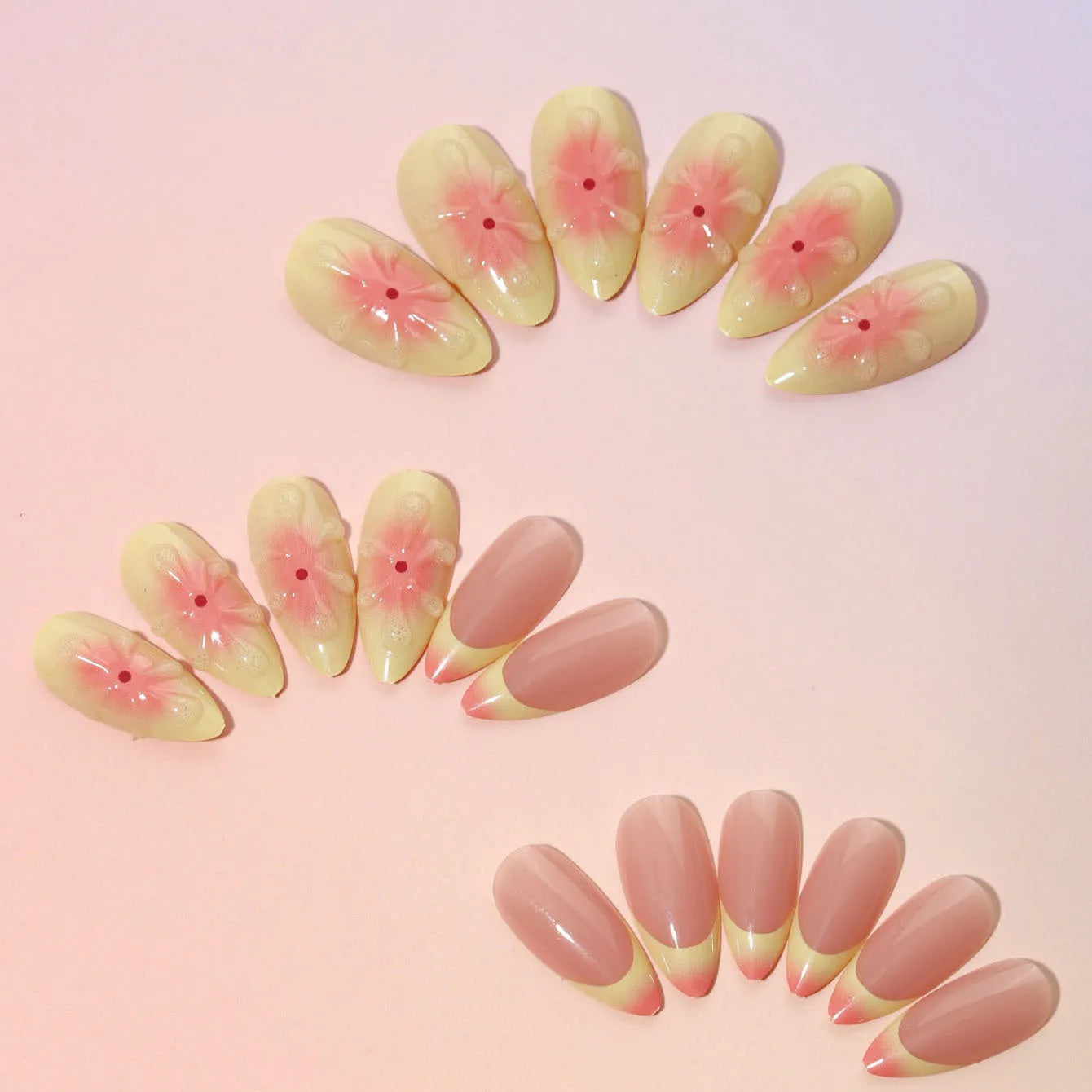 Set of simple fake nails with pink and white cartoon 3D flower charms on a wearable armour base.