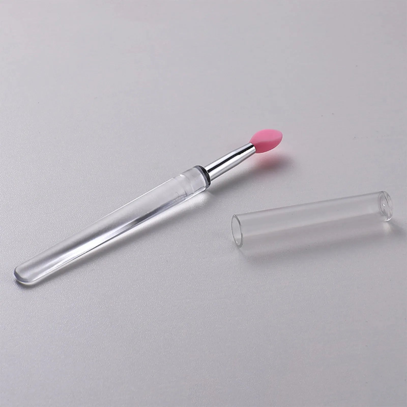 Silicone lip brush with protective cap for hygienic lip product application