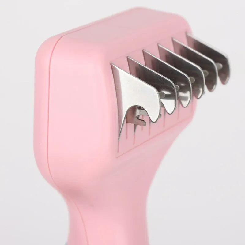 Pink stainless steel pet comb with comb teeth and an integrated knot-cutting knife blade.