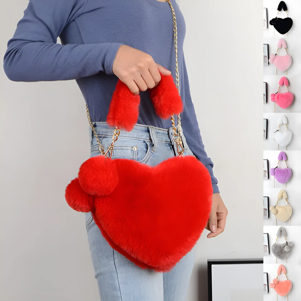 Soft plush women's handbag in a red heart shape with a zipper and detachable strap.