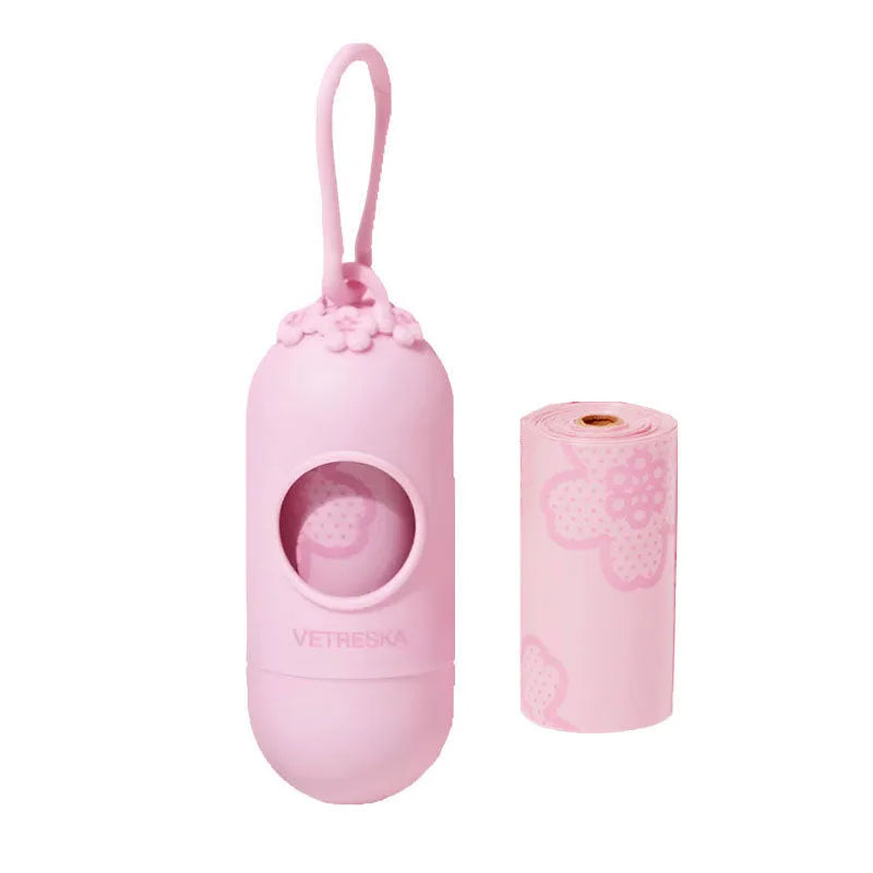 Refillable plastic dog poo bag dispenser capsule with a roll of scented biodegradable bags in strawberry design.