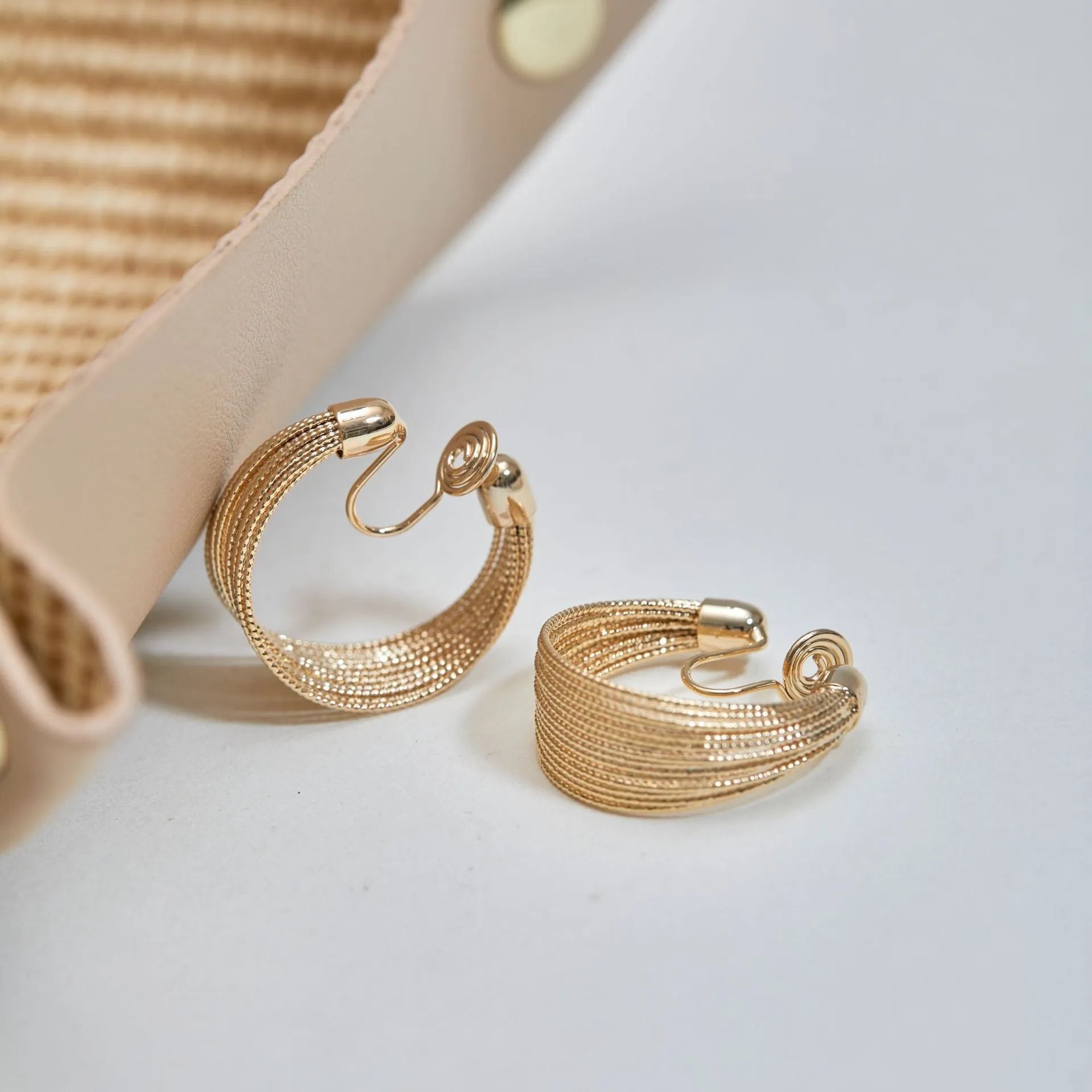 Geometric copper earrings with electroplated silver and gold finishes, including stud and clip-on options