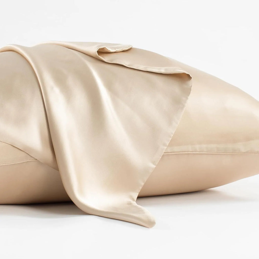 Dark gray envelope closure silk pillowcase on a bed