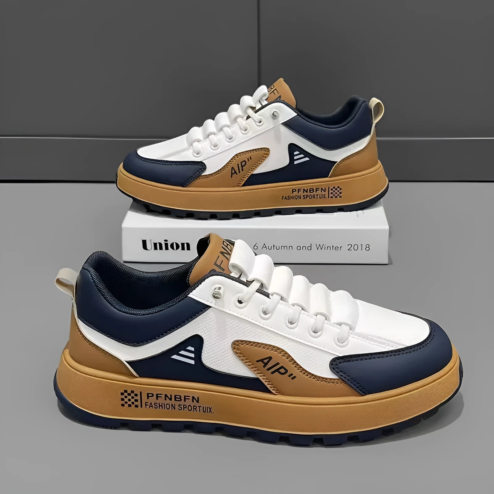 Men's white casual trainers with orange, black, or brown accents and round toe.