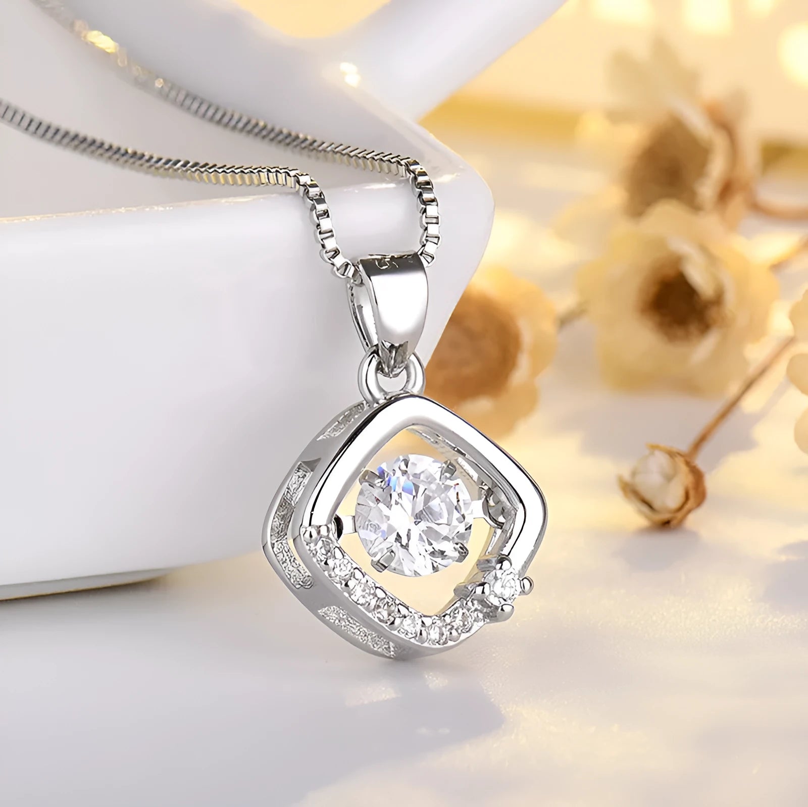 Heart-shaped sterling silver necklace with crown and bow pendant details