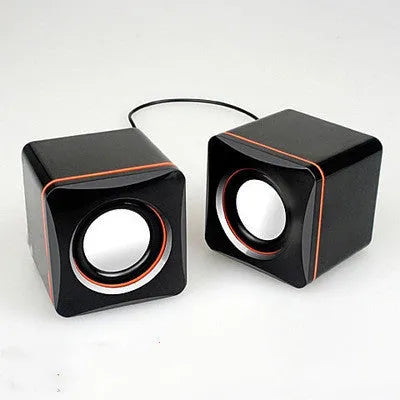 Small black square USB-powered computer speaker for desktop audio enhancement