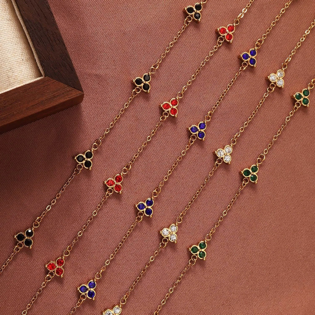 Women's stainless steel bracelet with three triangular charms set with coloured zircon stones.