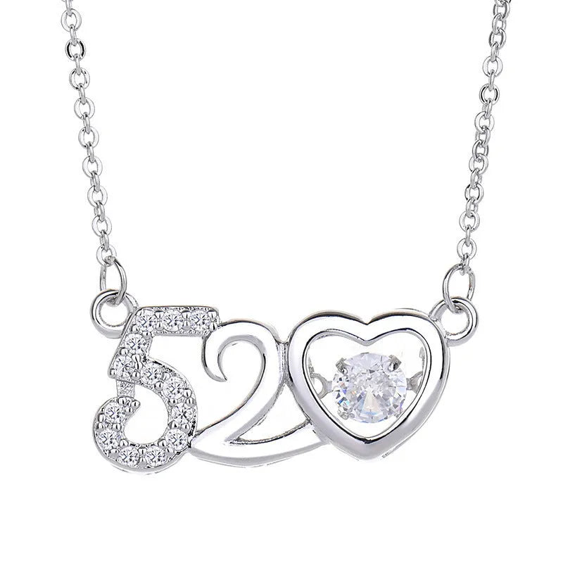 Heart-shaped sterling silver necklace with crown and bow pendant details