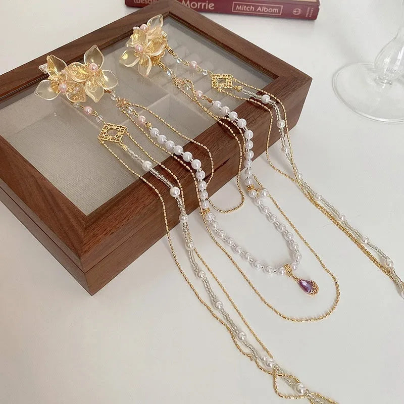 Gold women's hairpin with a pearl diamond flower and a long tassel.