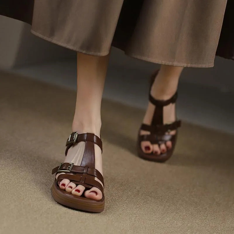 Black women's retro platform sandals with a T-buckle strap and chunky heel.