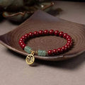 Handmade wave-shaped bracelet with alternating cinnabar and copper beads.