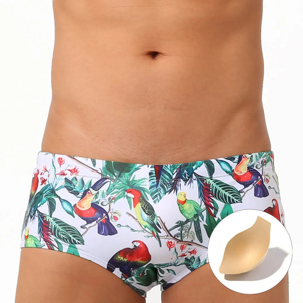 Men's floral and bird print nylon swimming trunks in boxer brief style with cup cover.