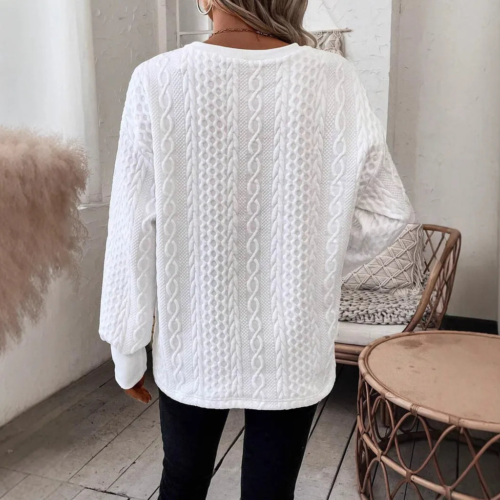 Milky white loose fit long sleeve t-shirt with a 3D pattern on a hanger