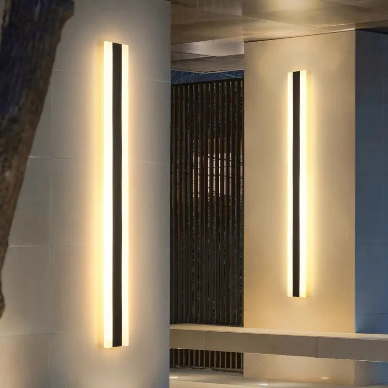 150cm long straight outdoor LED wall lamp with wrought iron housing, shown mounted on an exterior wall.