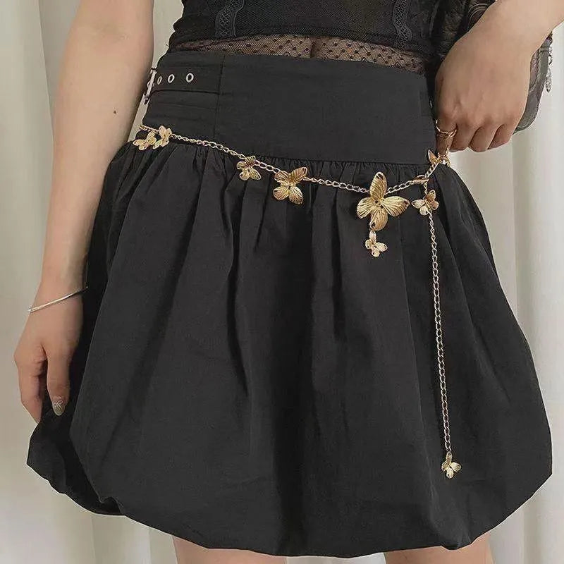 Gold and silver alloy waist chain with butterfly ornament, showing 104cm length.