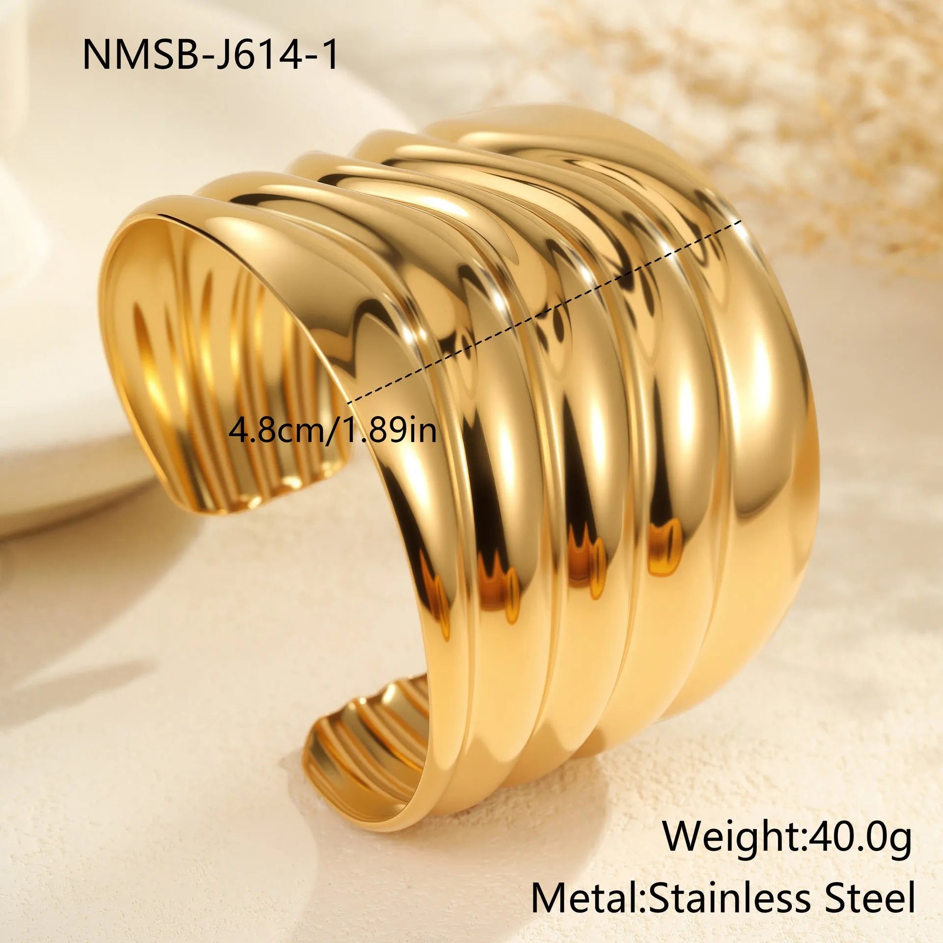 Women's exaggerated wide stainless steel bracelet with geometric wave design and niche opening in gold finish