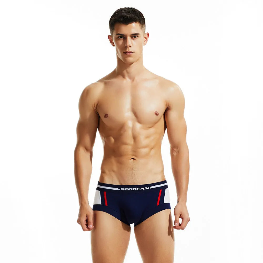 Men's cotton low waist boxer shorts in red, dark blue, and light grey colours laid flat.